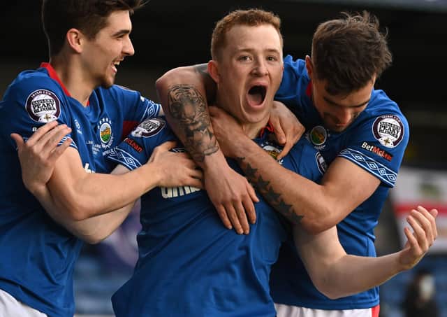 Shayne Lavery (centre) grabbed the Irish Cup final spotlight by breaking the deadlock in Lurgan for Linfield over Larne. Pic by Pacemaker.