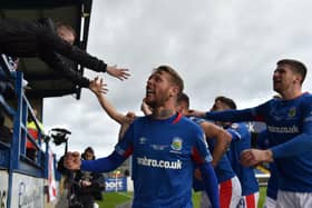 Kirk Millar and Linfield players share in the celebrations with supporters inside Mourneview Park. Pic by Pacemaker.