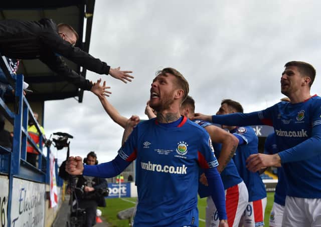 Kirk Millar and Linfield players share in the celebrations with supporters inside Mourneview Park. Pic by Pacemaker.