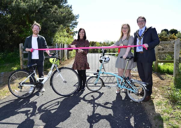 Infrastructure Minister Nichola Mallon has opened Phase 3 of the Blaris Greenway which connects Sprucefield Park and Ride with the Halftown Road providing a safe route to walk, wheel or cycle. Joining Minister Mallon to cut the ribbon are Sustrans Routes and Network Officer, Thomas McConaghie , Lady Mayoress of Lisburn & Castlereagh City Council Sarah Trimble and Mayor of Lisburn & Castlereagh City Council, Councillor Nicholas Trimble