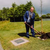 Mayor Cllr Jim Montgomery plants Covid memorials.