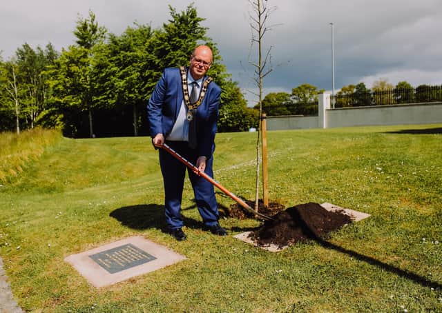 Mayor Cllr Jim Montgomery plants Covid memorials.