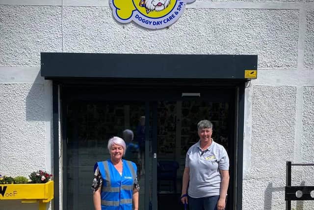 Staff at Doggos Doggy Daycare, including Sue and dog Hunter, are backing the challenge, having donated generously and sponsored the team at Via Wing's t-shirts
