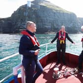 Minister Edwin Poots with Chief Fisheries Officer Mark McCaughan and Principal Scientific Officer Colin Armstrong viewing the thousands of seabirds comprising razor-bills, guillemots, fulmars, kittiwakes and puffins