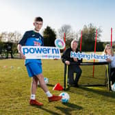 Pictured left to right: Ballykeel FC player Ben
McCormick, with Roy Bell and Rebecca Noble from Power NI.