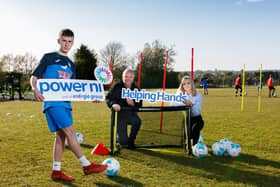 Pictured left to right: Ballykeel FC player BenMcCormick, with Roy Bell and Rebecca Noble from Power NI.