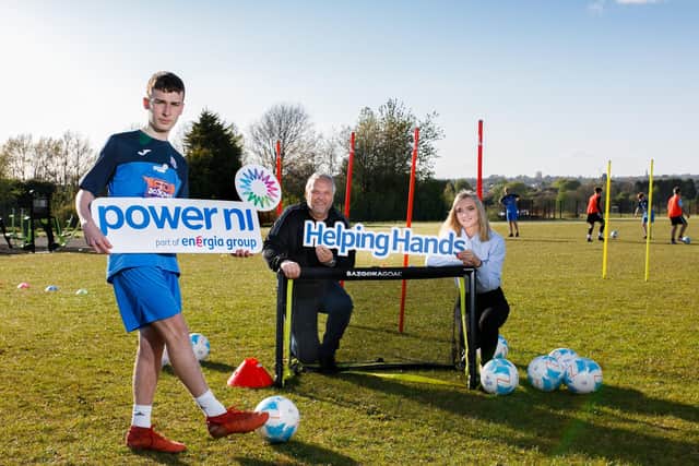 Pictured left to right: Ballykeel FC player Ben
McCormick, with Roy Bell and Rebecca Noble from Power NI.
