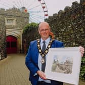 Cllr Jim Montgomery with a painting of the Barbican Gate by his former school teacher, Mr Harry Boyd which he is contributing to the Centenary Collections project.