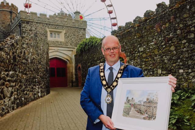 Cllr Jim Montgomery with a painting of the Barbican Gate by his former school teacher, Mr Harry Boyd which he is contributing to the Centenary Collections project.