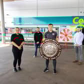 At the opening of Lusty's Centra Larne Port are Larne footballer Graham Kelly (centre) and owner Raymond Lusty (back right) with members of the store team.