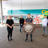 At the opening of Lusty's Centra Larne Port are Larne footballer Graham Kelly (centre) and owner Raymond Lusty (back right) with members of the store team.