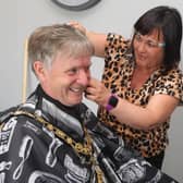 Kerry Macauley, proprietor of Buzz Cutz which has relocated to Millburn Community Association’s premises, give the Mayor, Alderman Mark Fielding, a hair cur during his visit