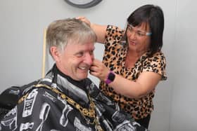 Kerry Macauley, proprietor of Buzz Cutz which has relocated to Millburn Community Association’s premises, give the Mayor, Alderman Mark Fielding, a hair cur during his visit