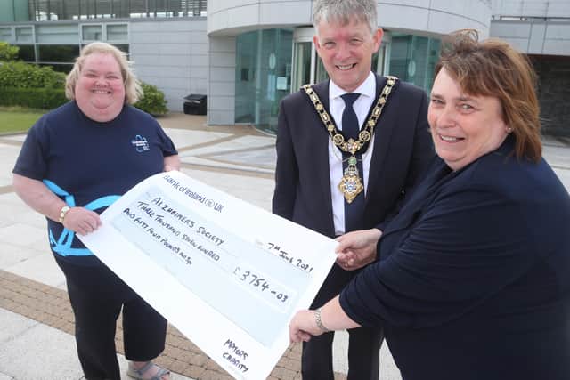 The Mayor of Causeway Coast and Glens Borough Council Alderman Mark Fielding and the Mayoress, Mrs Phyllis Fielding, make a special presentation to Alzheimer’s Society Fundraising Volunteer Sharon Neely totalling £3754.03