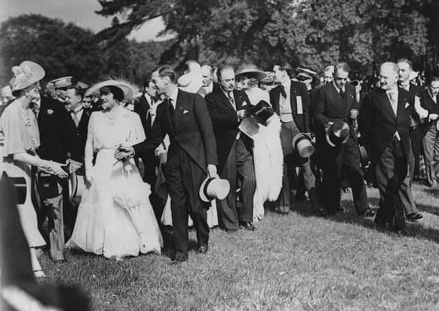 King George VI (1895-1952) and Queen Elizabeth (1900-2002) attend a garden party at the Château de Bagatelle in the Bois de Boulogne, during their State Visit to Paris, France, July 1938. On the right is French President Albert François Lebrun (1871-1950). The Queen is wearing a dress from the White Wardrobe designed for her by Norman Hartnell to mark the death of her mother, the Countess of Strathmore. Picture: Photo by Topical Press Agency/Hulton Archive/Getty Images