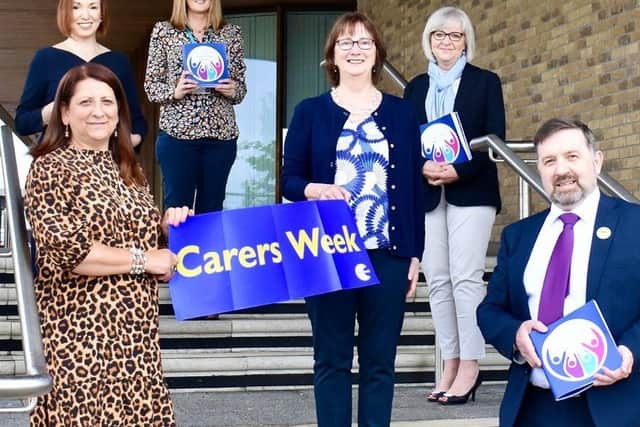 Health Minister Robin Swann pictured with Mandy Gourley, Mari McLaughlin, Winona Wilson, Jennifer Welsh, Chief Executive, Northern Trust and Claire Campbell, Carers Co-ordinator, NHSCT