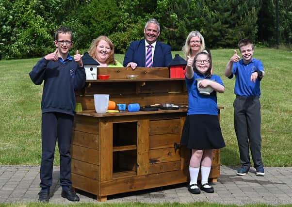 Thumbs up from Tor Bank School pupils Thomas Purdy, Lucia Carrigan and Daniel Magill for their new 'mud-kitchens'. Justice Minister Naomi Long joined Maghaberry Prison Governor David Savage for delivery of the 'mud-kitchens' built by prisoners for children with severe, profound and multiple learning difficulties at Tor Bank School in Dundonald. Pictured also is School Principal Claire Breen. Picture: Michael Cooper