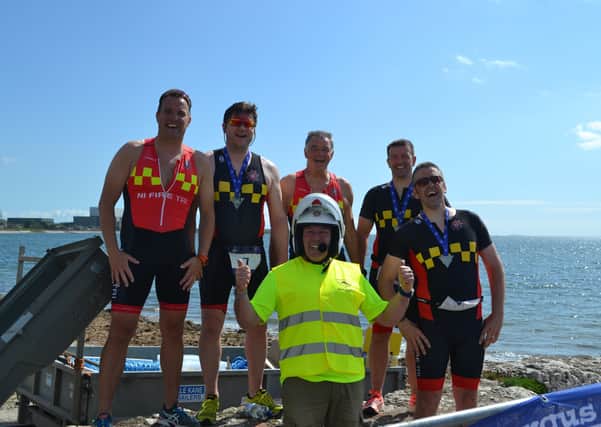 Northern Ireland Fire and Rescue Service Triathlon Club, and at the front retired fire officer Willy Lavery, winners of the inter services Emergency Team Competition.