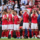 Denmark's players react as paramedics attend to Denmark's midfielder Christian Eriksen after he collapsed on the pitch during the UEFA EURO 2020 Group B football match between Denmark and Finland at the Parken Stadium in Copenhagen on June 12, 2021. (Photo by FRIEDEMANN VOGEL/POOL/AFP via Getty Images)