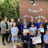 St. Nicholas' PS in Carrickfergus has been recognised with the Digital Schools Award for Northern Ireland.  Pictured celebrating the achievement are Laura Moloney, ICT co-ordinator and principal Mr Kieran Austin with P1, P4 and P7 pupils.