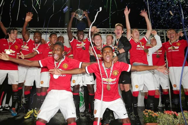 Manchester United celebrate winning the 2014 Premier Section trophy.