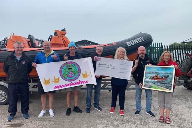 Members of Lough Neagh Dunkers hand over a cheque to Lough Neagh Rescue after raising £2597.