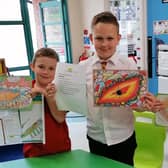 Jack, Junior and Luke from Bridge Integrated PS show off some of their work on their Shared Education creative writing project using Story Builder