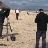 UTV's Paul Reilly filming at Whiterocks Beach Portrush