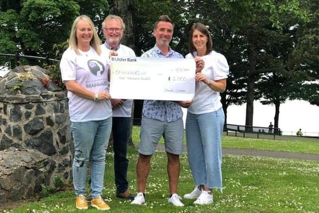 Brainwaves NI chairperson Colin McMillan and committee member Jennifer Arbuthnot with Alan and Joanne Coates, from Newtownabbey, who raised £2000 for the charity with a fundraising event.