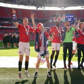 Brad Lyons (far left) celebrates Morecambe’s play-off win over Newport County