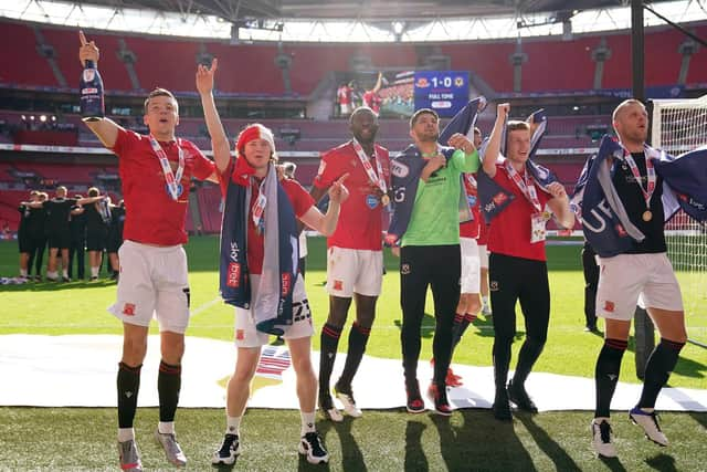 Brad Lyons (far left) celebrates Morecambe’s play-off win over Newport County