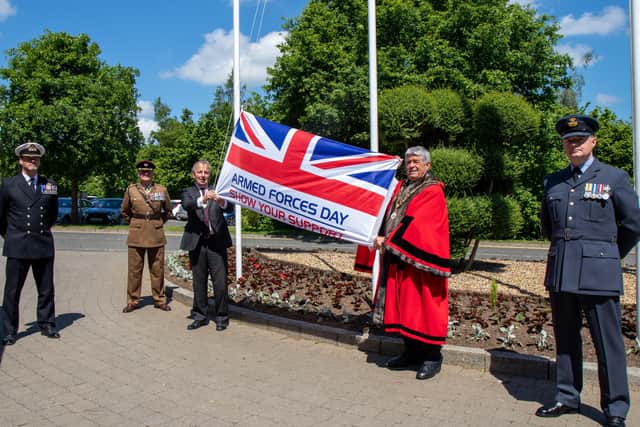 Mayor of Antrim and Newtownabbey, Cllr Billy Webb and Deputy Lieutenant of Co Antrim, Danny Kinahan raise the Armed Forces Flag at Mossley Mill. They are joined by Commander J Patterson (Royal Navy), Lieutenant Colonel K Thomas (Army) and Squadron Leader M Mayo (RAF).