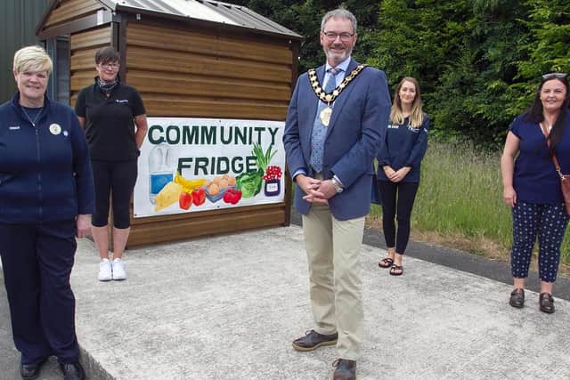 Pictured is Mayor Cllr William McCaughey and Patricia Mulligan, DfC with retailer representatives at the launch of the Community Fridge at Eden Garden Allotments.
