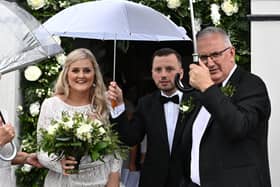 Laura and Philip Kennedy on their wedding day at Banbridge Road Presbyterian Church in Dromore today with Philip's father Danny Kennedy. 
Pic by Colm Lenaghan/Pacemaker