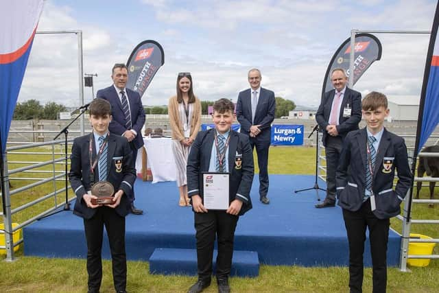 Cookstown High School pupils Ben Smyton, William Hamilton and John Mark McCrea receive their ABP Angus Youth Challenge finalist trophy alongside teacher Robyn Stewart. Also on the stage is George Mullan, ABP Managing Director, Martin McKendry, CAFRE College Director and Charles Smith, NI Angus Producer Group.