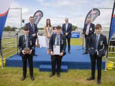Cookstown High School pupils Ben Smyton, William Hamilton and John Mark McCrea receive their ABP Angus Youth Challenge finalist trophy alongside teacher Robyn Stewart. Also on the stage is George Mullan, ABP Managing Director, Martin McKendry, CAFRE College Director and Charles Smith, NI Angus Producer Group.