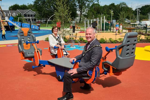 Chair of Mid Ulster District Council, Councillor Paul McLean, and Deputy Chair of Mid Ulster District Council, Councillor Christine McFlynn, try out some of the new equipment at the refurbished all inclusive play area at Ballyronan Marina.