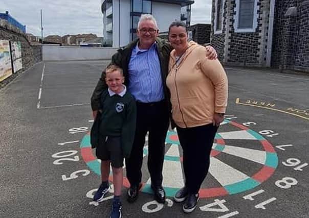 Niall McKinney pictured with Kerrie McCaughan, who was a pupil in his first class at St Patrick's PS in Portrush, and her son Alfie who was in Mr McKinney's last class