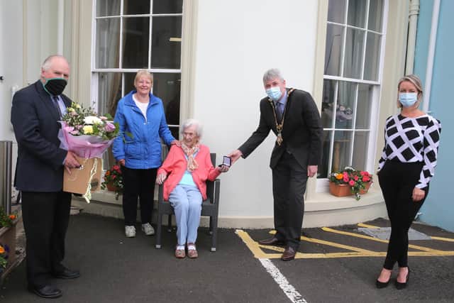 Centenary coin recipient Elizabeth MacRory receives her presentation from the Mayor of Causeway Coast and Glens Borough Council Councillor Richard Holmes along with her friend Jean Burgess and Amanda Duncan (Manager at Seabank Residential Home in Portrush)