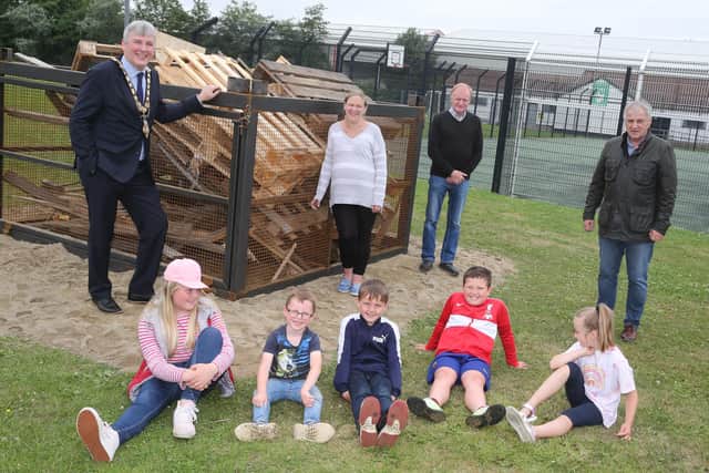 Mayor of Causeway Coast and Glens Borough Council, Richard Holmes, Maurice Bradley MLA, Councillor Russell Watton and Cassandra Hanna with local children at the Windyhall beacon