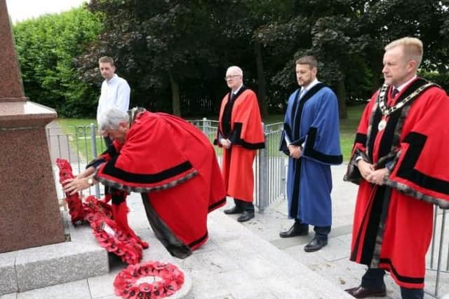 The Mayor, Cllr Billy Webb, placing the wreath on the memorial, looking on are the Deputy Mayor, Cllr Stephen Ross, Ald Julian McGrath, Cllr Victor Robinson and Ald Phillip Brett.