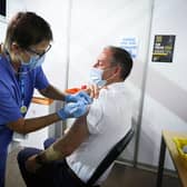 Paul Givan is pictured receiving his vaccine from Rose Scott. Photo by Kelvin Boyes / Press Eye.