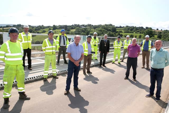 The Mayor of Causeway Coast and Glens Borough Council Councillor Richard Holmes pictured with Councillor Sean McGlinchey, Councillor Dermot Nicholl, Ian Buchanan and some of those involved with the construction of the A6 road scheme in Dungiven
