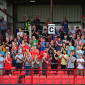 Larne fans salute the players after their win