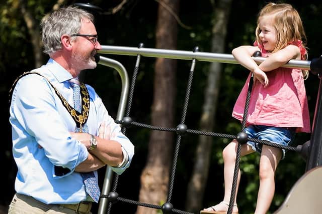 Mayor Cllr William McCaughey has a chat with a young play park user