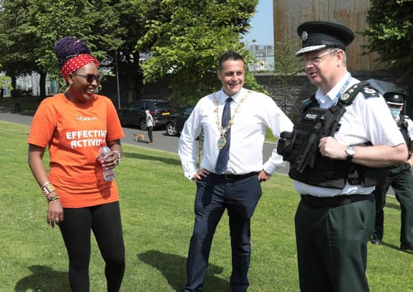 PSNI Chief Constable Simon Byrne chatting to Mayor Graham Warke and Lilian Seenoi-Barr at a NW Migrants Forum family fun day at Brooke Park in Londonderry.