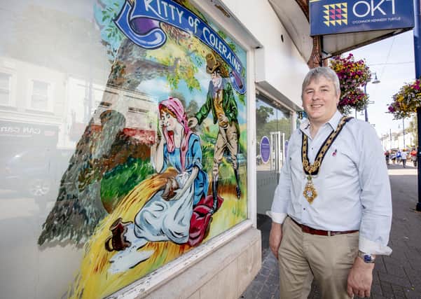 Mayor of Causeway Coast and Glens Borough Council Councillor Richard Holmes pictured during a recent visit to Coleraine town centre to view the shop window artworks created by local artist Mark Christie.