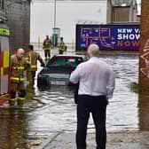 A car became stuck on the Lisburn Road during the flooding and heavy rain on Tuesday. (Photo: Arthur Allison/Pacemaker Press)