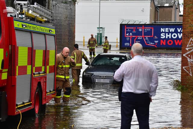 A car became stuck on the Lisburn Road during the flooding and heavy rain on Tuesday. (Photo: Arthur Allison/Pacemaker Press)