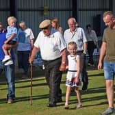 Hilbert Willis completing his 100-lap walk at Lakeview Park along with grandsons David and Adam and great-grandchildren Ollie and Amelia Lily. Pic courtesy of Loughgall FC